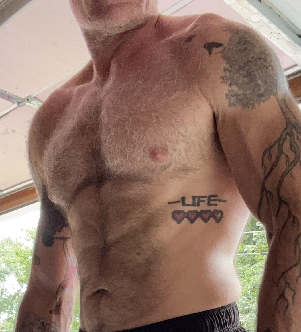Progress photo at 207 pounds in a garage, different lighting and angle