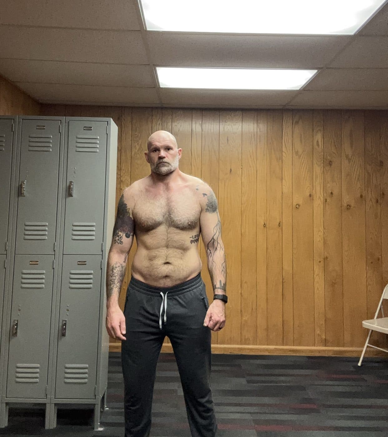 Front progress photo at 207 pounds in a gym locker room, March 2026